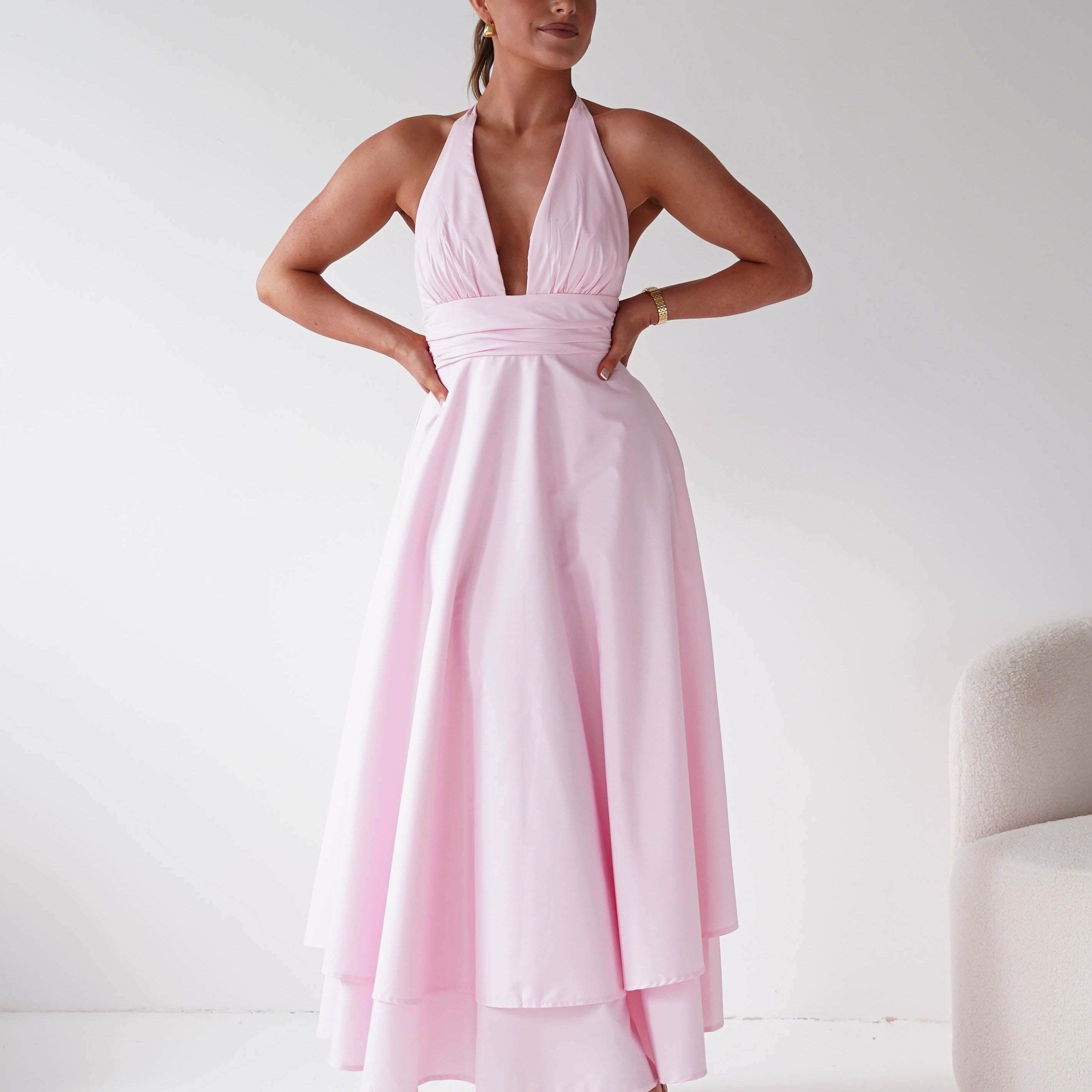 Women wearing a stunning wedding guest dress in the colour pink